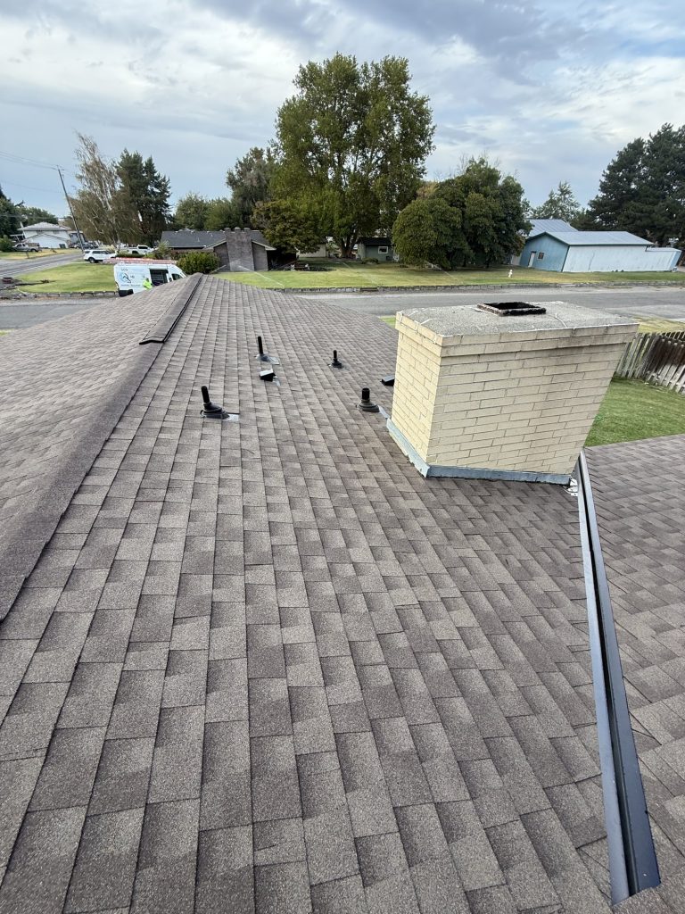 New GAF Timberline NS shingles in Barkwood with open metal valleys on a south Kennewick roof replacement